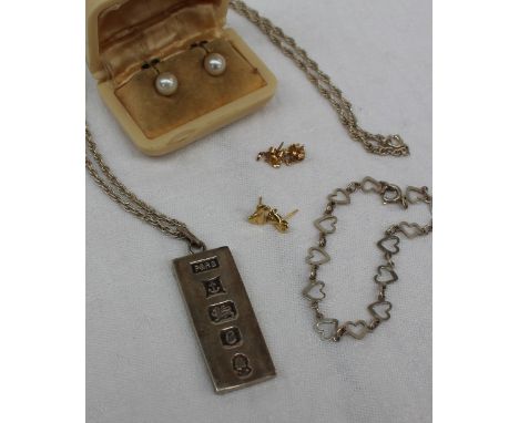 A silver ingot pendant on a chain, together with a pair of pearl earrings, a white metal bracelet and two pairs of yellow met