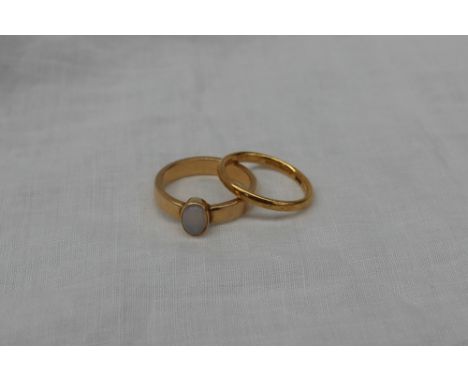 A 22ct yellow gold wedding band, approximately 3 grams, together with a yellow metal ring set with an opal, approximately 5.5