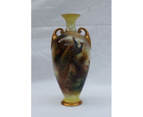A Royal Worcester Hadley ware porcelain twin handled vase, with a flared neck, decorated with a peacock and peahen in a tree 