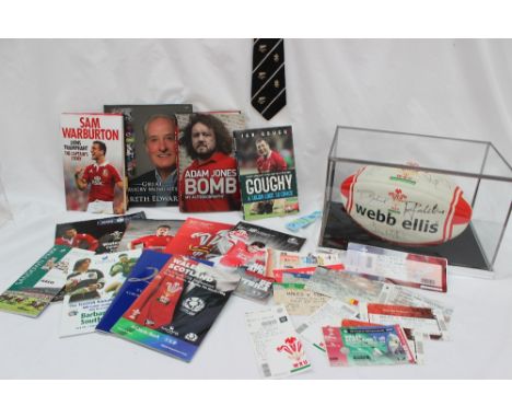 A signed Webb Ellis Rugby ball in a case together with signed books, 'Goughy", 'Adam Jones Bomb', 'Lions triumphant The Capta