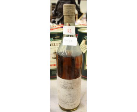 Sealed bottle, thought to contain cognac, labelled 'No. 20 Grande Champagne Cognac, shipped by John Exshaw, 1943, Peter Kaye 