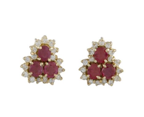 A PAIR OF RUBY AND DIAMOND EARRINGSEach composed of a trio of oval-cut rubies to a round brilliant-cut diamond surround, moun
