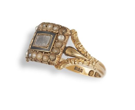 A 19TH CENTURY MOURNING RING, 1835Set centrally with a frame of enamel surrounded by half-pearls, between carved trifurcated 