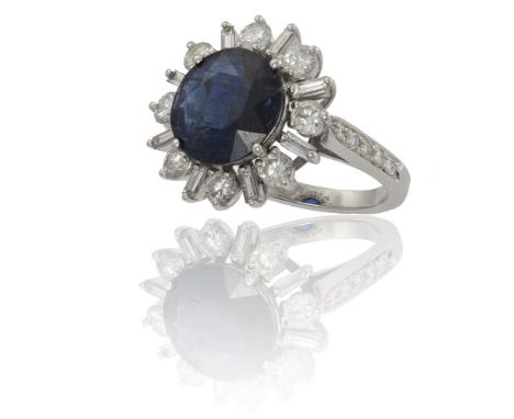 A SAPPHIRE AND DIAMOND CLUSTER RINGThe round-cut sapphire weighing 5.22cts, in a four-claw setting, within a round brilliant 