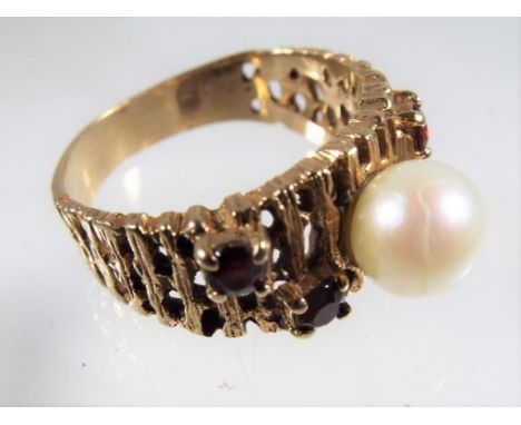 A lady's unmarked presumed 9 carat gold evening ring set with pearl and three rubies, approximate weight 4.47 grams. Estimate