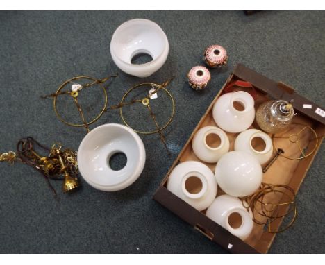 Two brass ceiling lights with white glass shades, a glass oil lamp and further quantity of glass shades - This lot MUST be pa