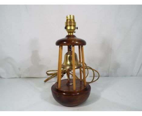 A good quality wood and brass table lamp in the form of a buoy with enamel insert bearing the P & O logo marked S.S. Strathmo