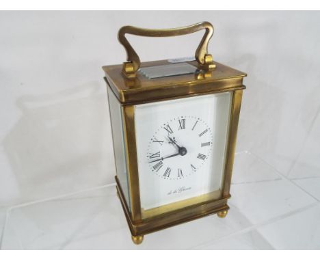 A brass cased carriage clock, the dial scribed 'De la Grense'  Roman numerals, visible platform escapement, serial number 542