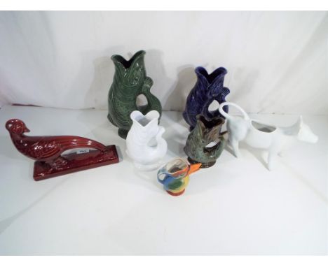Four Glug jugs to include three Dartmouth examples, the largest 26 cm (h),  a ceramic model of a pheasant, a jug in the form 
