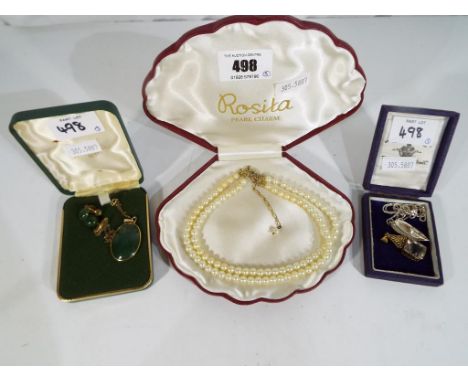 A good collection of jewellery to include a cased double stranded pearl choker, a jade pendant set in 12 k gold, a silver cha