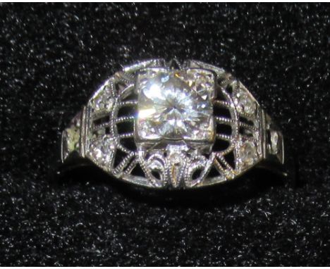 ART DECO WHITE METAL PIERCED RING SET CENTRAL DIAMOND, ½ct AND FOUR SMALLER DIAMONDS (TWO SHOULDER STONES MISSING), 3.1g GROS