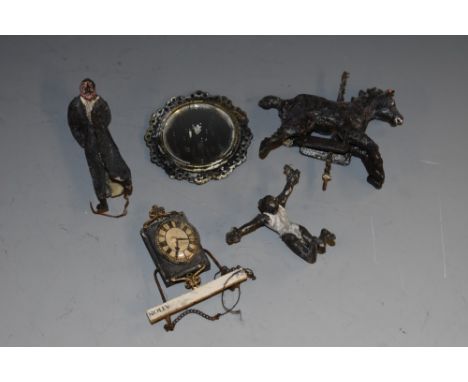 A collection of five filming miniatures from the filming of Moulin Rouge; a carousel horse, acrobat, male figure, clock, and 