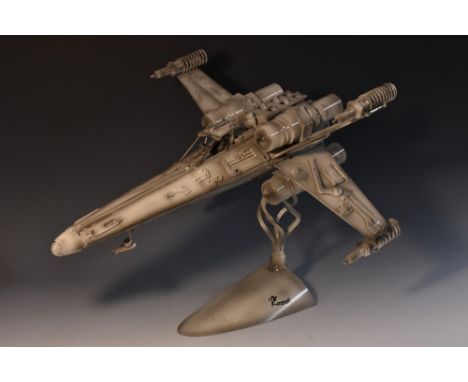 Movie Props - a one-off metal sculpture, of a Star Wars X Wing Fighter, mounted in flight, domed base, twisted support, signe