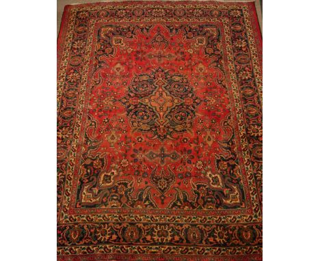 Large Persian Meshed rug carpet, decorated with urn motifs, large centre blue rosette, 337cm x  270cm   Condition Report   Cl