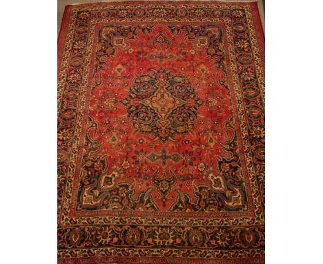 Large Persian Meshed rug carpet, decorated with urn motifs, large centre blue rosette, 337cm x  270cm   Condition Report   Cl