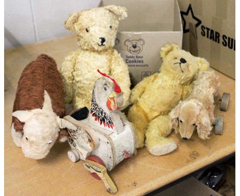 Teddy Bears and Toys including a Merrythought Hereford Bull with label to foot, 28cm by 18cm, a Steiff daschund on wheels 27c