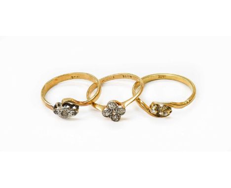 A Diamond Cluster Ring, the old cut diamonds in white millegrain settings, to a yellow tapered shoulder plain polished shank,