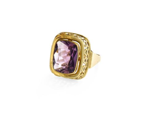 An Amethyst Ring, the rectangular cushion shaped amethyst in a yellow rubbed over setting, to a tapered shoulder plain polish