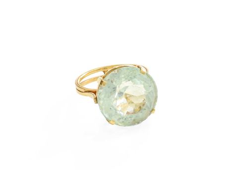 An Aquamarine Ring, the round cut aquamarine in a yellow claw setting, to a tapered shoulder double row plain polished shank,