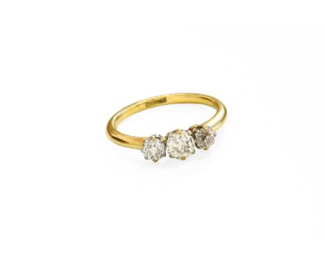 A Diamond Three Stone Ring, the graduated old cut diamonds in yellow claw settings, to a tapered shoulder plain polished shan