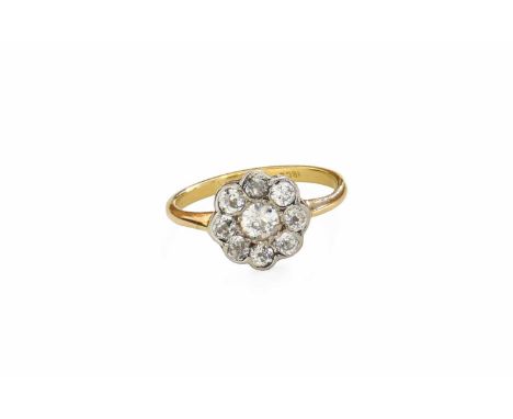 A Diamond Cluster Ring, the old cut diamond within a border of smaller old cut diamonds, in white claw and rubbed over settin