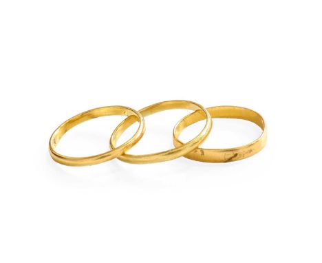 Two 22 Carat Gold Band Rings, finger sizes I and K; and Another Band Ring, stamped ‘18’, finger size M22 carat – 2.3 grams. R