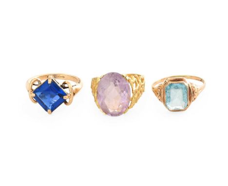 An Amethyst Ring, indistinctly marked, finger size K; A 9 Carat Gold Synthetic Spinel Ring, finger size L1/2; and A Blue Glas