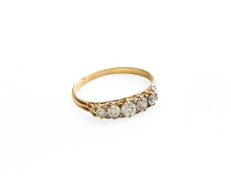 A Diamond Five Stone Ring, the graduated old cut diamonds with rose cut diamond accents, in yellow claw settings, to a tapere