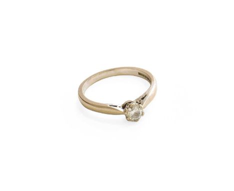 An 18 Carat White Gold Diamond Solitaire Ring, the round brilliant cut diamond in a double claw setting, to a tapered shoulde