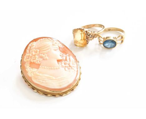 A Citrine Ring, stamped '9CT', finger size K; A 9 Carat Gold Blue Topaz Ring, finger size K1/2; and A 9 Carat Gold Cameo Broo