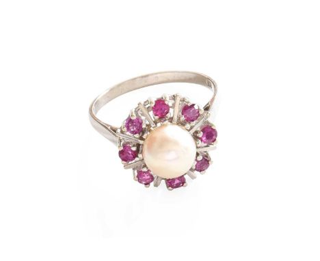A Cultured Pearl and Synthetic Ruby Cluster Ring, the cultured pearl within a border of round cut rubies spaced by white plai