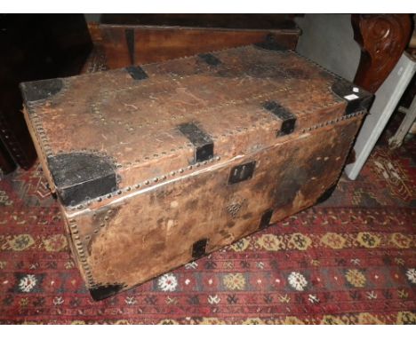 A 19TH CENTURY LEATHER COVERED AND STUD DECORATED TRAVELLING TRUNK with metal mounts, 85cm wide 