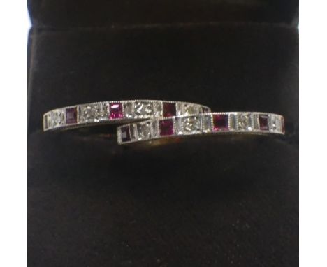 A RUBY AND DIAMOND HALF ETERNITY RING and one other similar ring, both rings size O