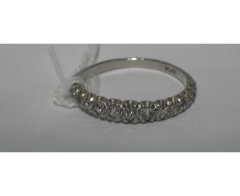 A HALF DIAMOND ETERNITY RING IN PLATINUM,ring size T