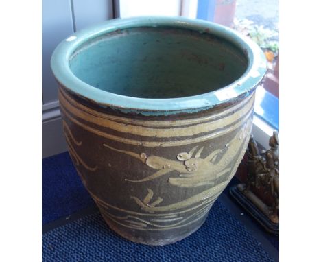 A CHINESE GARDEN PLANTER decorated with a dragon, 43cm high