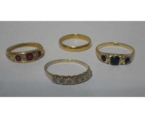 A SAPPHIRE AND DIAMOND GYPSY STYLE RING, a ruby and diamond gypsy style ring, a 9ct dress ring and a 22ct wedding band (4)