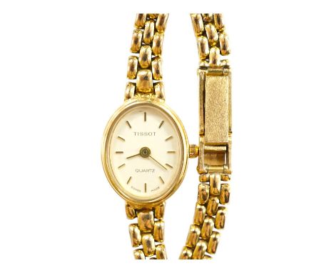 A lady's modern 9ct gold Tissot quartz wrist watch, on a 9ct gold bracelet, gross weight 19.5 grams. Condition - poor to fair