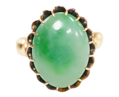 A mid 20th century yellow metal and single stone cabochon jade set ring, size Q, gross weight 5.6 grams. Condition - fair