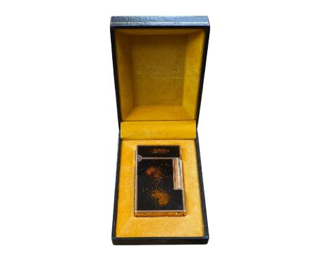 A cased Dupont 'gold dust' lighter with booklet. Condition - good
