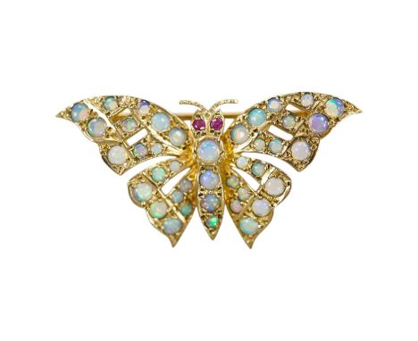 A modern 9ct gold and opal cluster set butterfly brooch, with ruby eyes, width 40mm, gross weight 4.8 grams. Condition - good