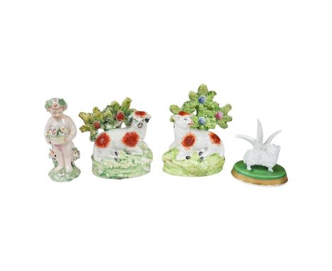 A pair of early 19th century pearlware models of sheep, an English porcelain ‘sheep’ ring tree and a Derby figure of a cherub