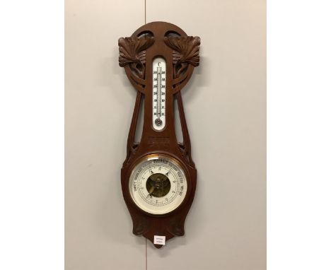 A late 19th century French Art Nouveau carved oak aneroid barometer and thermometer, height 76cm. Condition - fair to good