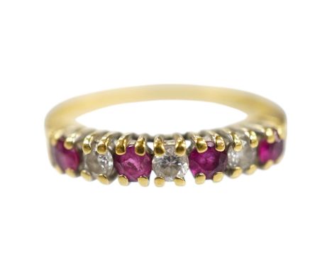 A modern 18ct gold, four stone ruby and three stone diamond set half hoop ring, size P, gross weight 2.8 grams. Condition - f