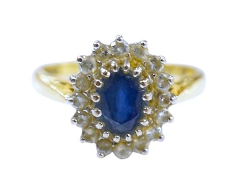 A modern 18ct gold, sapphire and diamond set oval cluster ring, size P/Q, gross weight 4.9 grams. Condition - fair
