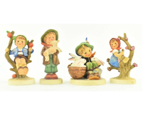 M. J. Hummel, Goebel - four 20th century German bisque china figurines. The lot to include figurine of a boy with three rabbi