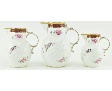 Coalport - a set of three reproduction 20th century graduating Caughley mask head jugs. Each with characteristic mask spout, 