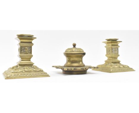 A pair of late 19th century Victorian square brass candlesticks together with a similar lidded inkwell. The candlesticks each