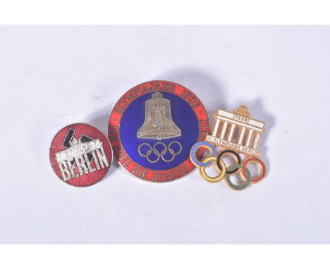 THREE BERLIN OLYMPIC BADGES TO INCLUDE A VISITORS BADGE with white enamel and five coloured rings, a blue and red enamelled b