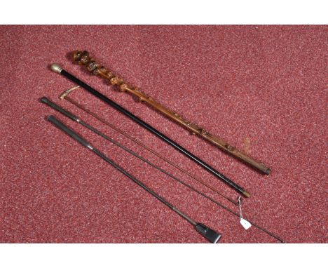 A SELECTION OF WAKLING STICKS AND RIDING CROPS, to include a black walking stick with a dented and well-worn white metal top,