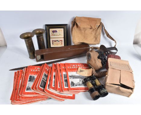 A BOX OF ASSORTED MILITARIA, MAGAZINES AND A SWORD, this lot includes two WWII or post war gas masks, one boxed and one in a 